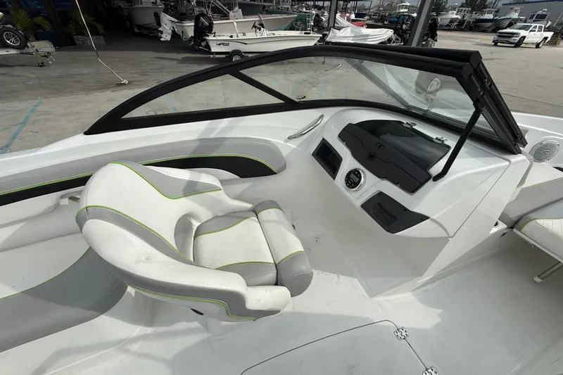 Slide: The Image of 2019 Tahoe 700 boat interior with white and green seating, dashboard, and windshield. - 11