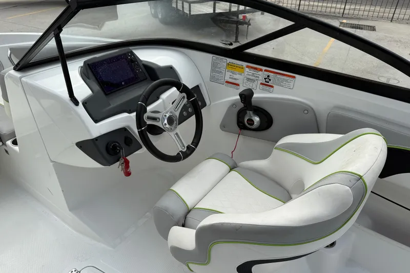 Slide: The Image of Cockpit of 2019 Tahoe 700 boat with steering wheel and control panel. - 12