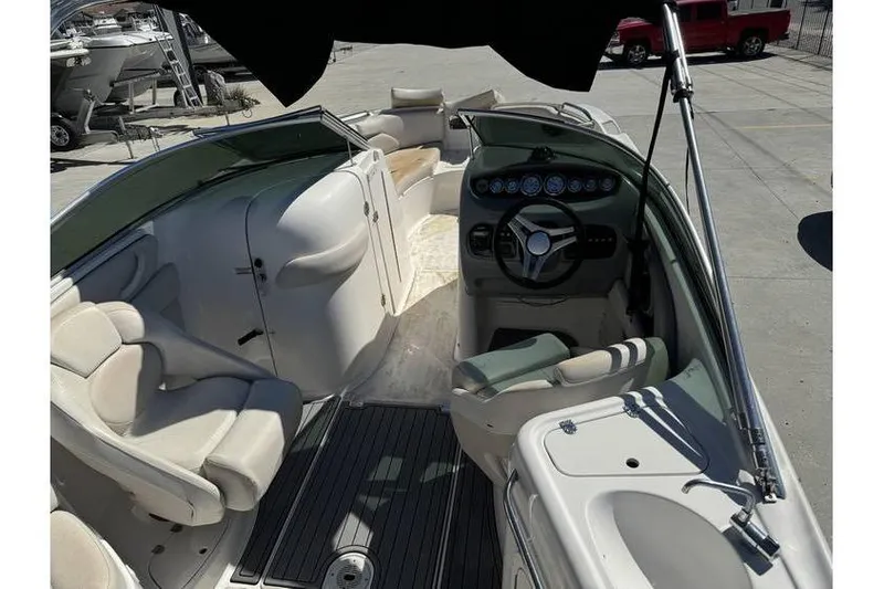 Slide: The Image of 2004 Chaparral Sunesta 254 boat interior with steering wheel and seating area. - 10