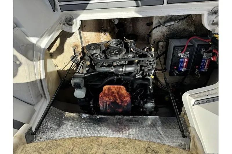 Slide: The Image of 2004 Chaparral Sunesta 254 engine compartment with visible engine and battery setup. - 14