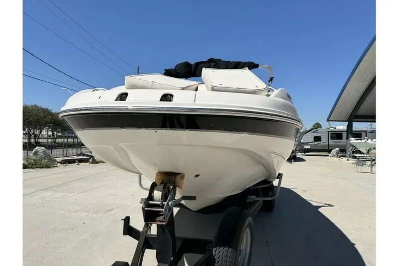 Slide: The Image of 2004 Chaparral Sunesta 254 boat on trailer under clear blue sky. - 2