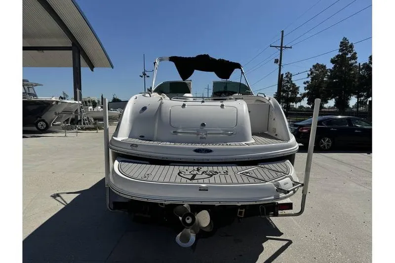 Slide: The Image of 2004 Chaparral Sunesta 254 boat, rear view, parked outdoors on a sunny day. - 6