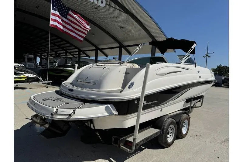 Slide: The Image of 2004 Chaparral Sunesta 254 boat on trailer, parked outdoors under a canopy. - 7