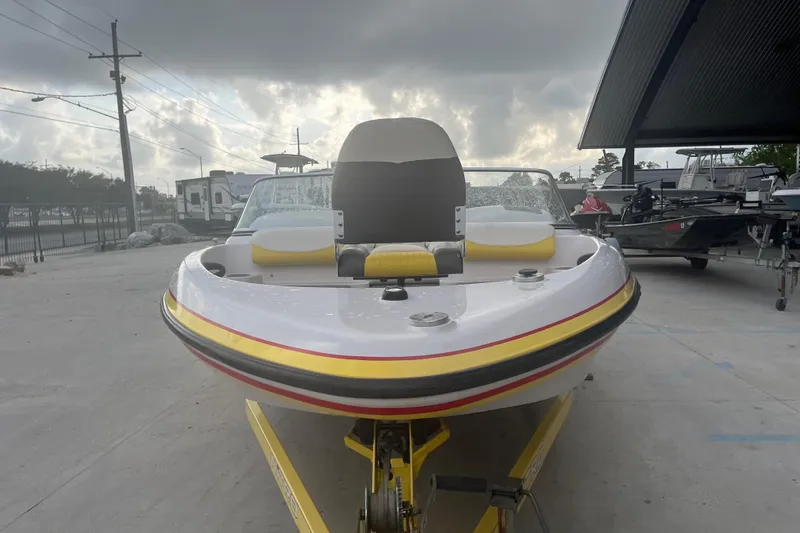 Slide: The Image of 2006 Nitro 189 Sport boat on trailer, parked outdoors under cloudy sky. - 2