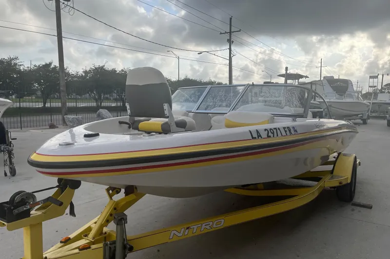 Slide: The Image of 2006 Nitro 189 Sport boat on trailer, parked outdoors under cloudy sky. - 3