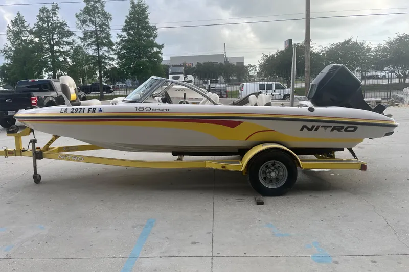 Slide: The Image of 2006 Nitro 189 Sport boat on trailer, parked outdoors, side view. - 4