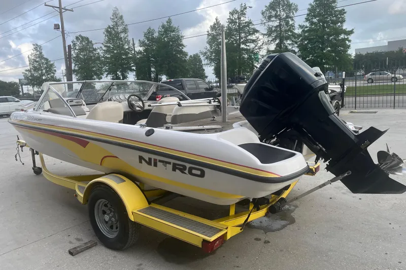 Slide: The Image of 2006 Nitro 189 Sport boat on yellow trailer, parked outdoors. - 5