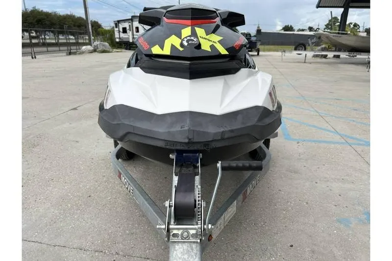 Slide: The Image of 2014 Sea-Doo Wake 155 jet ski on trailer, parked outdoors. - 2