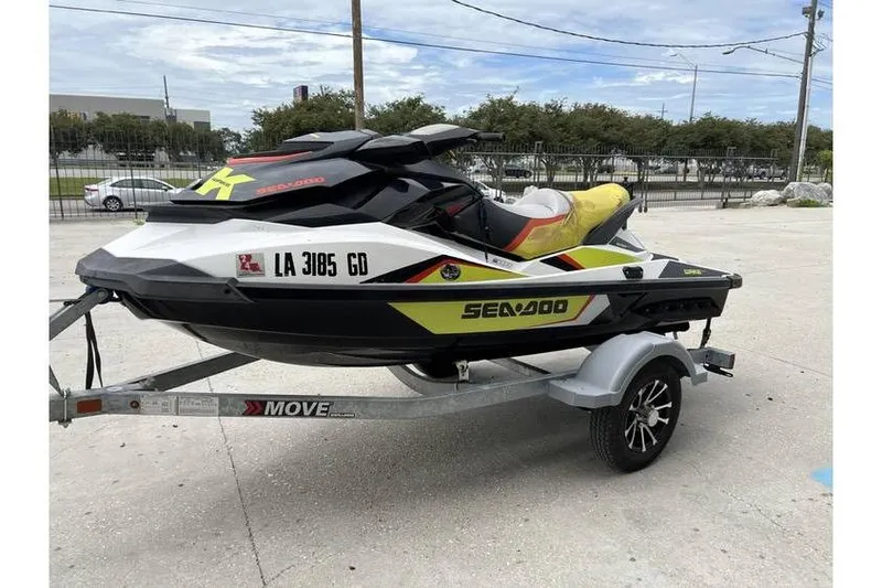Slide: The Image of 2014 Sea-Doo Wake 155 jet ski on trailer, parked outdoors. - 3