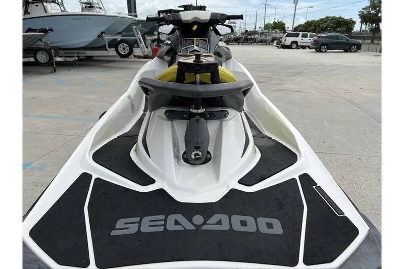 Slide: The Image of 2014 Sea-Doo Wake 155 jet ski parked in a marina, showcasing its sleek design. - 7