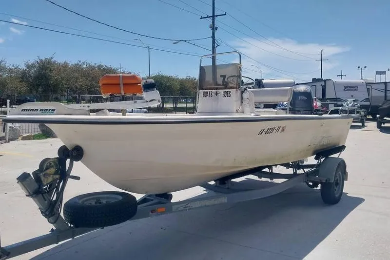 Slide: The Image of 2007 SeaStar 18cc boat on trailer, parked outdoors under clear sky. - 2