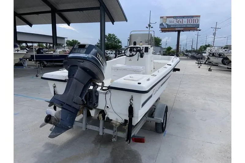 Slide: The Image of 2000 Leader 180 Catamaran with Yamaha outboard motor on trailer in boatyard. - 3