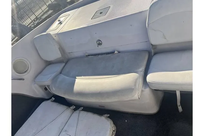 Slide: The Image of 2006 Tahoe 206 boat interior with white seating and storage compartments. - 10