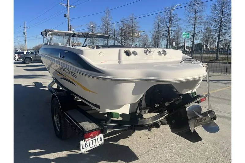 Slide: The Image of 2006 Tahoe 206 boat on trailer, parked outdoors on a sunny day. - 5
