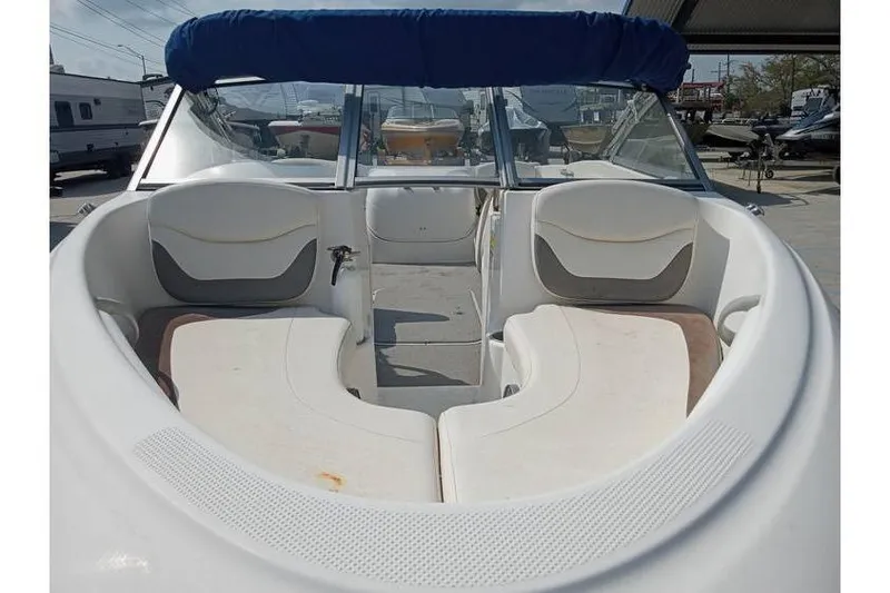 Slide: The Image of 2008 Bayliner 175 boat interior with white seating and blue canopy. - 5