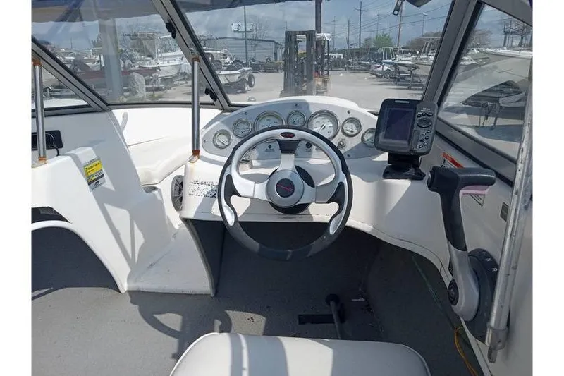 Slide: The Image of 2008 Bayliner 175 boat dashboard with steering wheel and gauges, featuring a GPS device. - 8