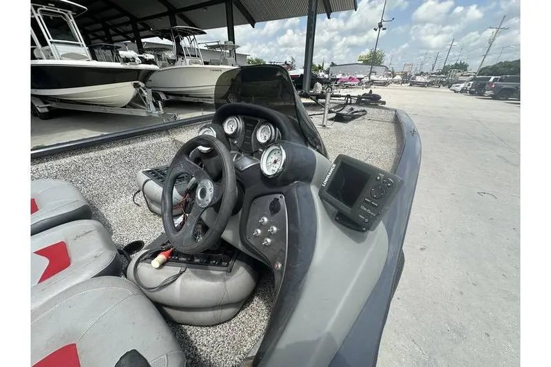Slide: The Image of 2015 Tracker Pro Team 190 TX boat dashboard with steering wheel and gauges. - 10