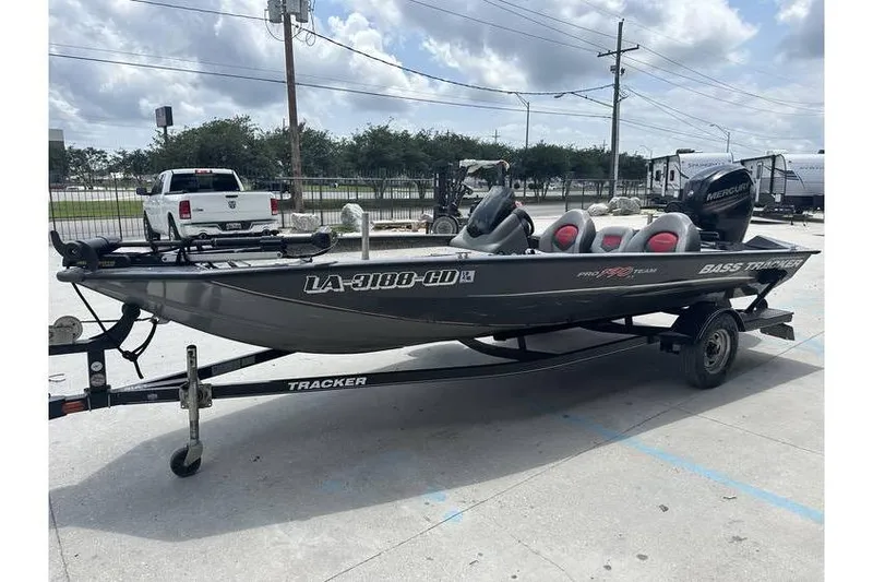 Slide: The Image of 2015 Tracker Pro Team 190 TX boat on trailer, parked outdoors. - 2