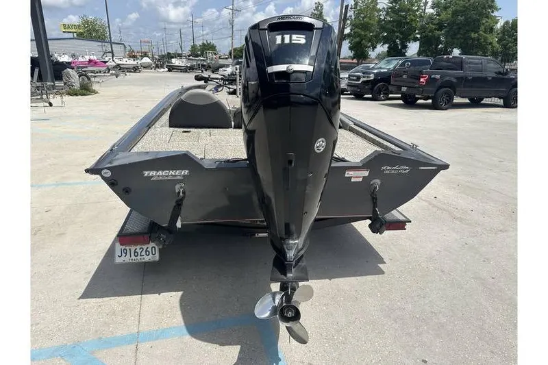 Slide: The Image of 2015 Tracker Pro Team 190 TX boat with Mercury 115 engine in parking lot. - 5