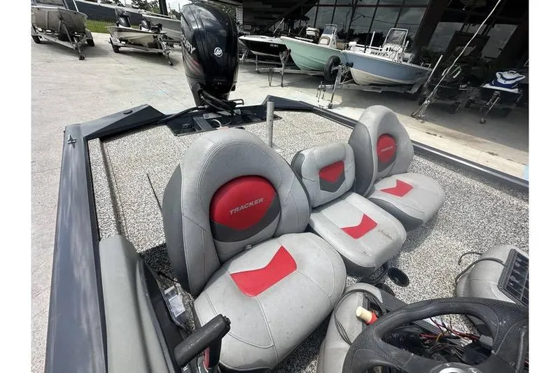 Slide: The Image of 2015 Tracker Pro Team 190 TX boat interior with red and gray seating. - 9