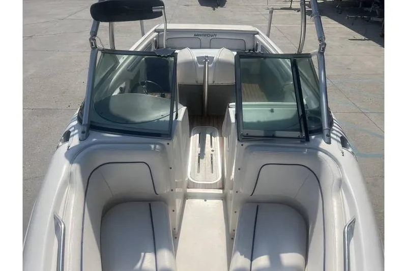 Slide: The Image of 1999 MasterCraft Prostar 205 boat interior with open windshield and seating. - 7