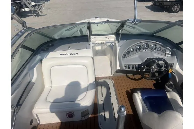 Slide: The Image of 1999 MasterCraft Prostar 205 boat interior with steering wheel and dashboard controls. - 8