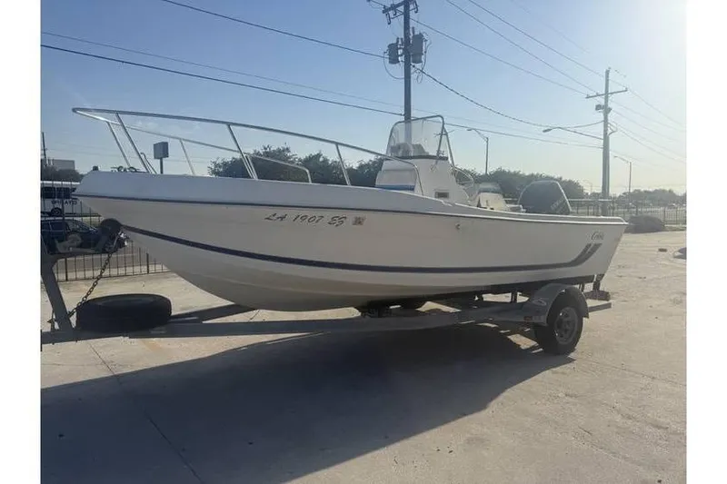 Slide: The Image of 1999 Cobia 194 Center Console boat on trailer in outdoor setting. - 2