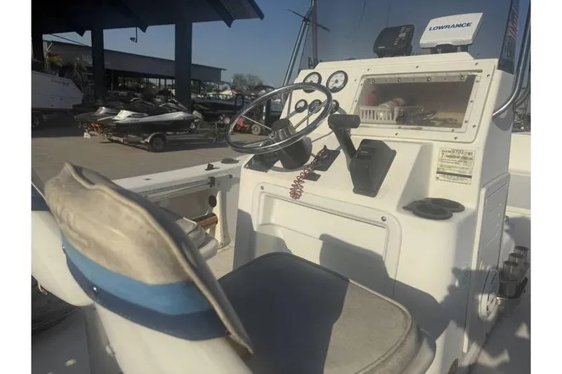 Slide: The Image of 1999 Cobia 194 Center Console boat interior with steering wheel and control panel. - 7