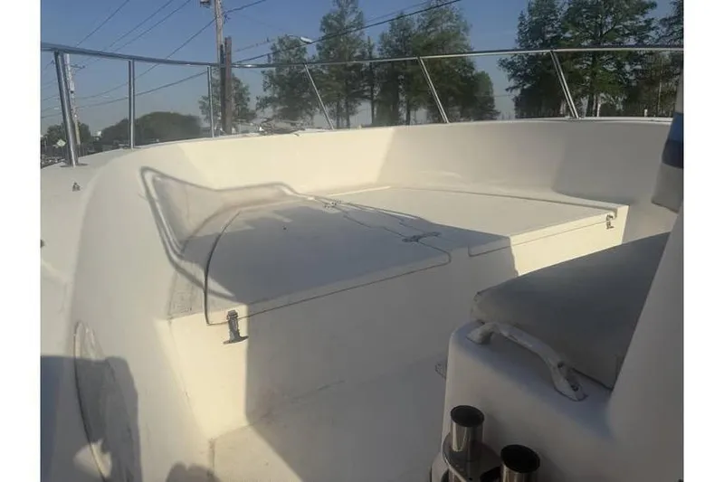 Slide: The Image of 1999 Cobia 194 Center Console boat interior with seating and storage. - 8