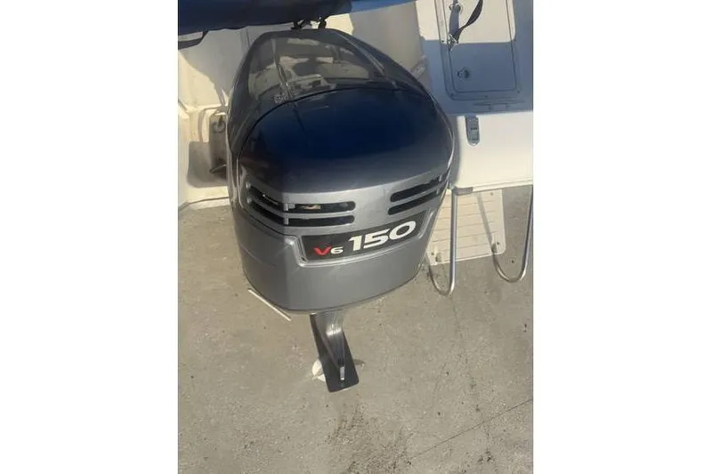 Slide: The Image of 1999 Cobia 194 Center Console with V6 150 outboard motor. - 9