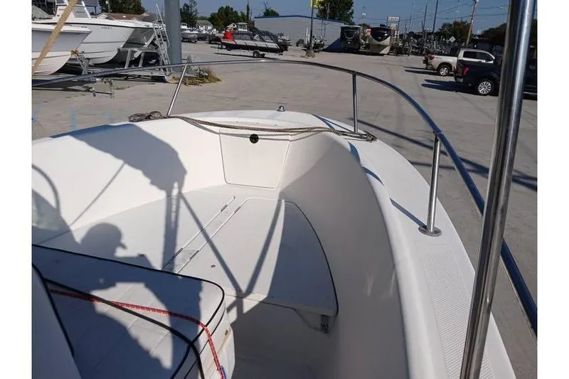 Slide: The Image of 2000 Trophy 1800 boat interior with white seating, parked in a marina. - 10