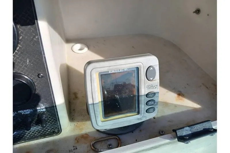 Slide: The Image of Eagle fish finder on 2000 Trophy 1800 boat dashboard, showing control buttons. - 14