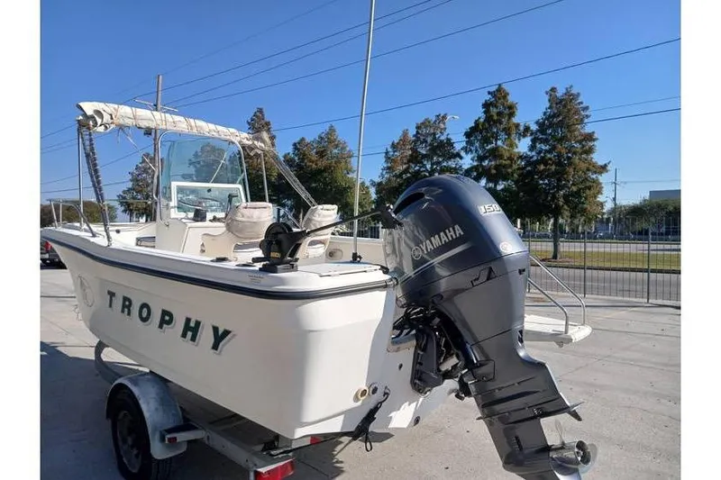 Slide: The Image of 2000 Trophy 1800 boat with Yamaha outboard motor on a trailer. - 2