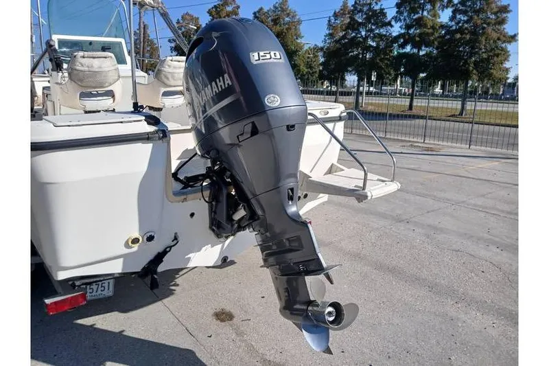 Slide: The Image of Boat with Yamaha 150 outboard motor, Trophy 1800 model, year 2000, parked outdoors. - 4