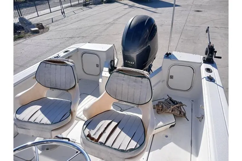 Slide: The Image of 2000 Trophy 1800 boat interior with two seats and an outboard motor. - 7