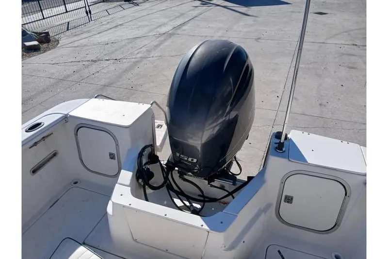 Slide: The Image of Outboard motor on a 2000 Trophy 1800 boat, docked on concrete surface. - 8