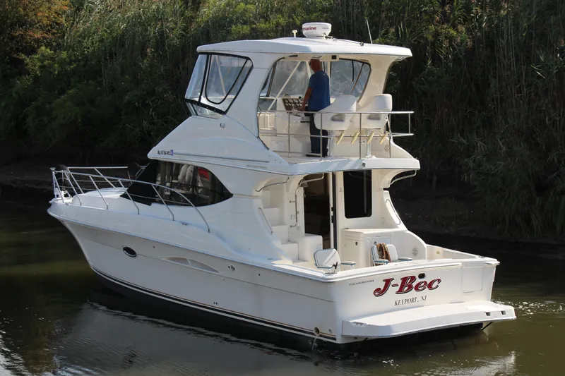 Slide: The Image of 2003 Silverton 38 Convertible yacht cruising on a calm river. - 12