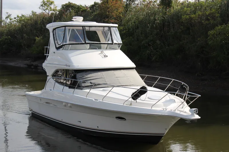 Slide: The Image of 2003 Silverton 38 Convertible yacht cruising on a calm river. - 19