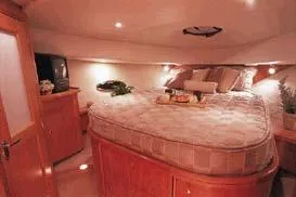 Slide: The Image of 2003 Silverton 38 Convertible helm with steering wheel, gauges, and navigation equipment. - 30