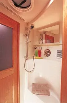 Slide: The Image of 2003 Silverton 38 Convertible boat interior with white seating and storage area. - 33