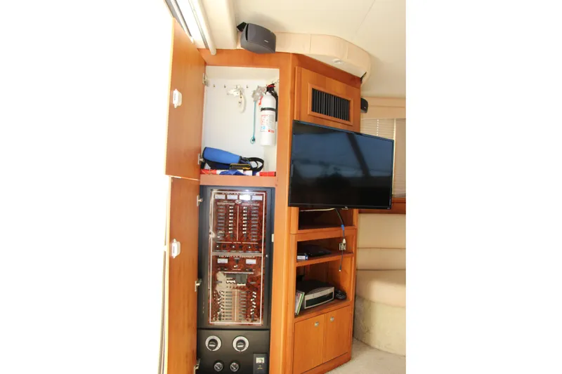 Slide: The Image of 2003 Silverton 38 Convertible interior with TV, control panel, and storage. - 38