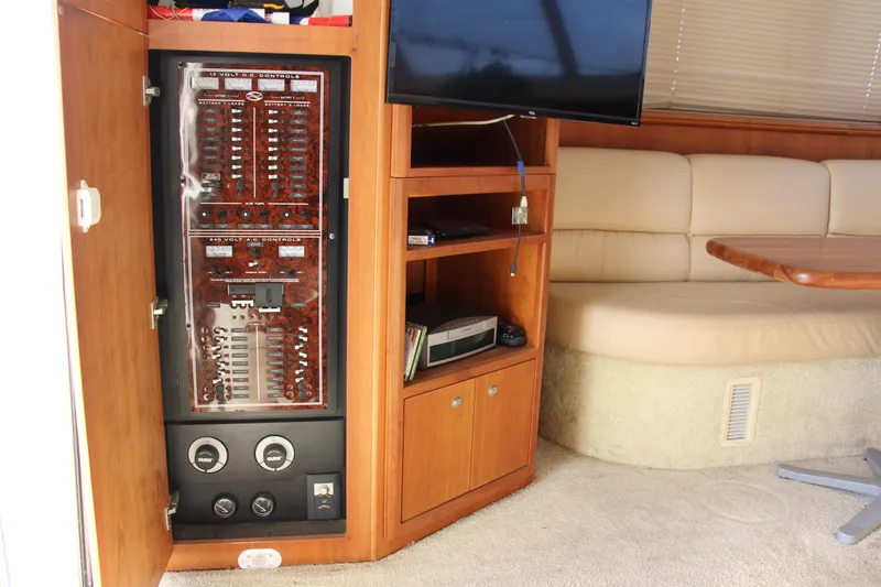 Slide: The Image of Interior of 2003 Silverton 38 Convertible yacht with control panel and seating area. - 39