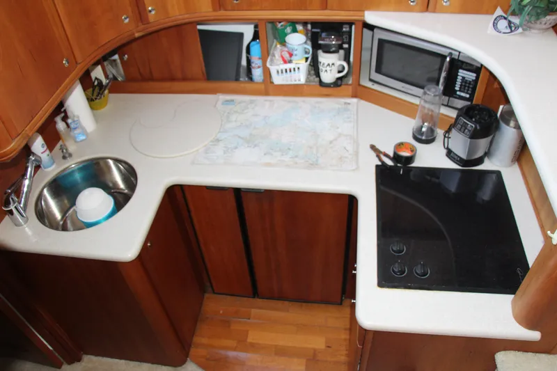 Slide: The Image of 2003 Silverton 38 Convertible yacht kitchen with sink, stove, and microwave. - 40