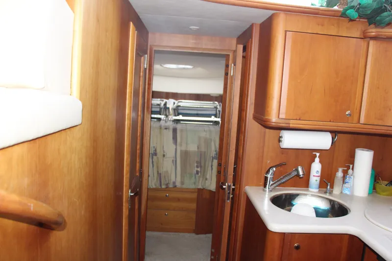 Slide: The Image of Interior of 2003 Silverton 38 Convertible yacht with wooden cabinetry and sink. - 43