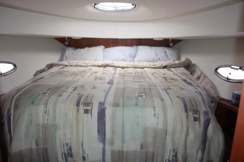 Slide: The Image of Cozy cabin bedroom in 2003 Silverton 38 Convertible yacht with patterned bedding. - 44