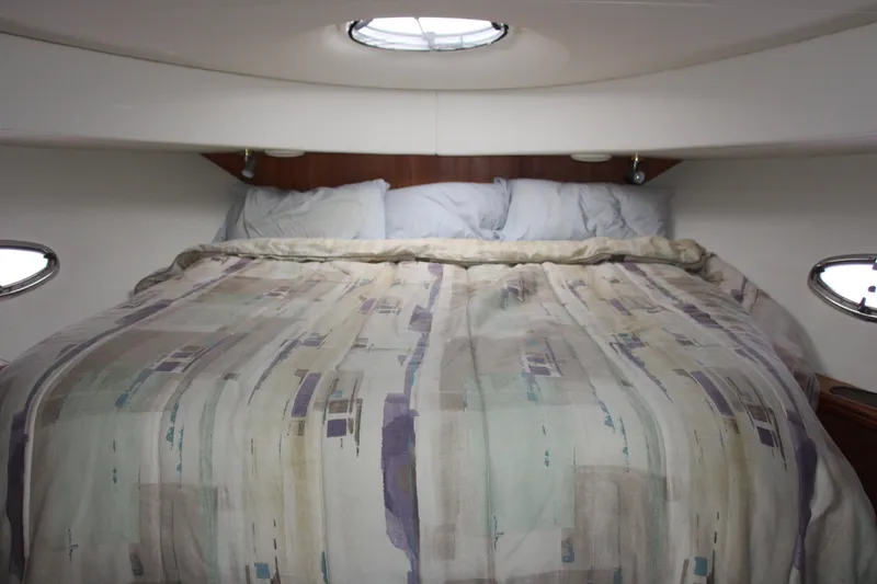 Slide: The Image of Cozy bedroom interior of 2003 Silverton 38 Convertible yacht with patterned bedding. - 45