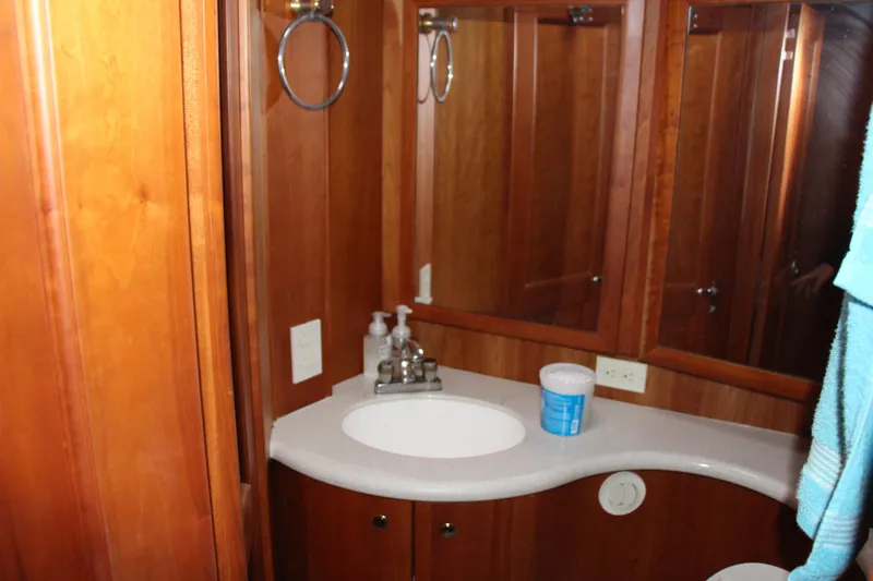 Slide: The Image of Bathroom interior of 2003 Silverton 38 Convertible yacht with wooden cabinetry and sink. - 48
