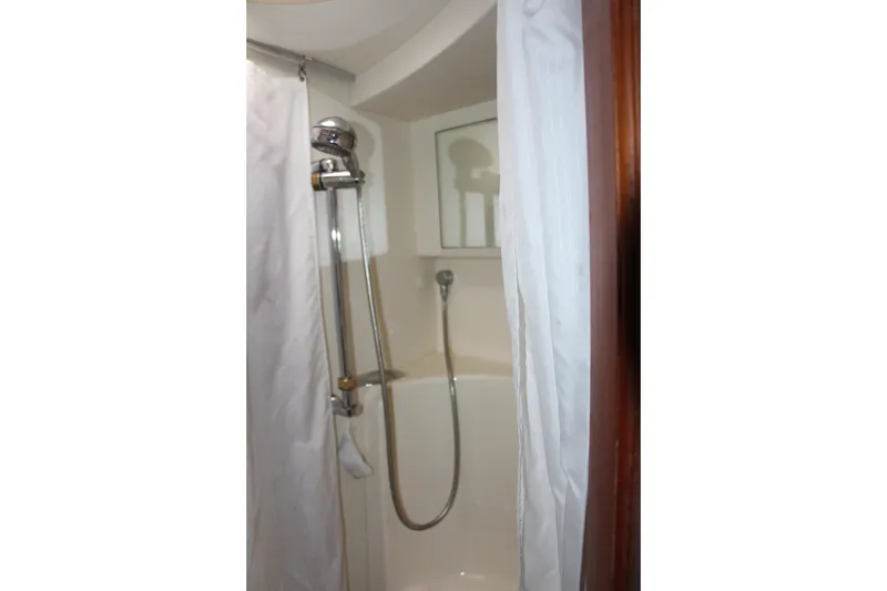 Slide: The Image of Shower area in 2003 Silverton 38 Convertible yacht with curtain and adjustable showerhead. - 50