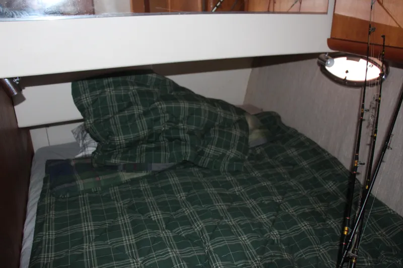 Slide: The Image of Cozy cabin bed in 2003 Silverton 38 Convertible yacht with plaid bedding. - 53