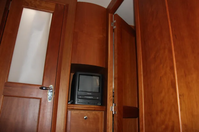 Slide: The Image of 2003 Silverton 38 Convertible interior with wooden cabinetry and a small TV. - 54